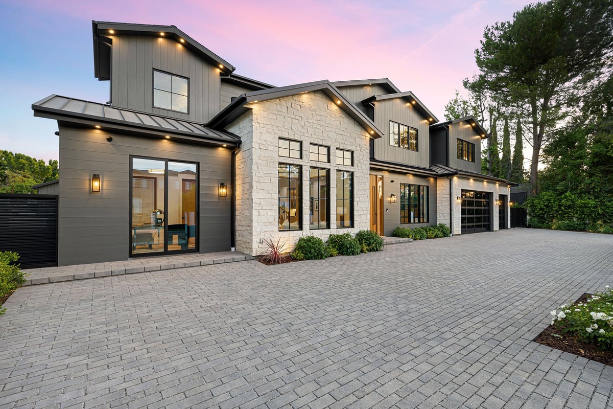 Modern luxury home exterior at sunset photographed for a real estate listing